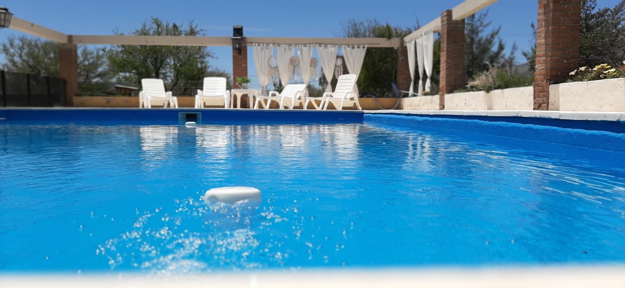 Pileta con reposeras y pérgola